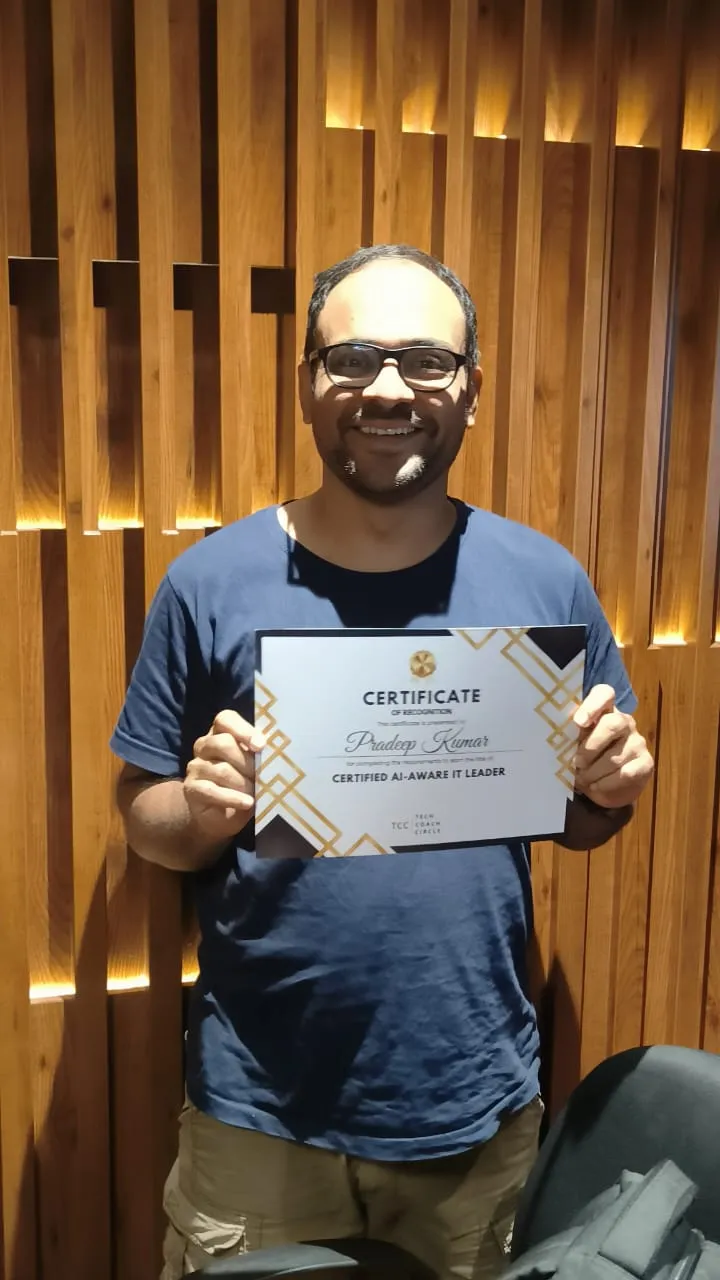 A graduate holding his Certified AI-Aware IT Leader certificate