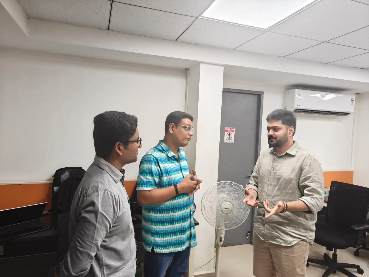 Three attendees in conversation after the talk