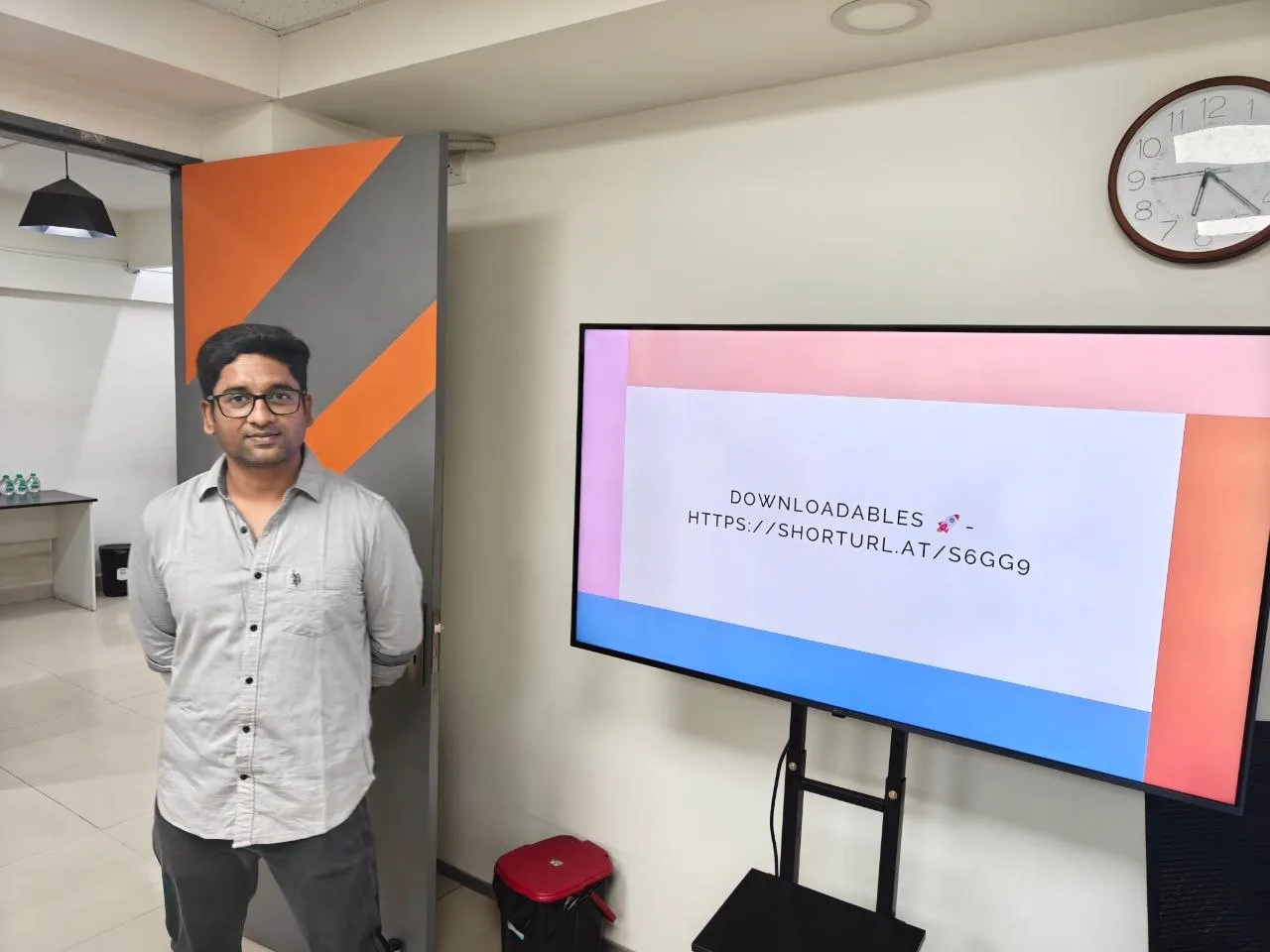 A Tech Coach Circle mentor beside a presentation screen before a session