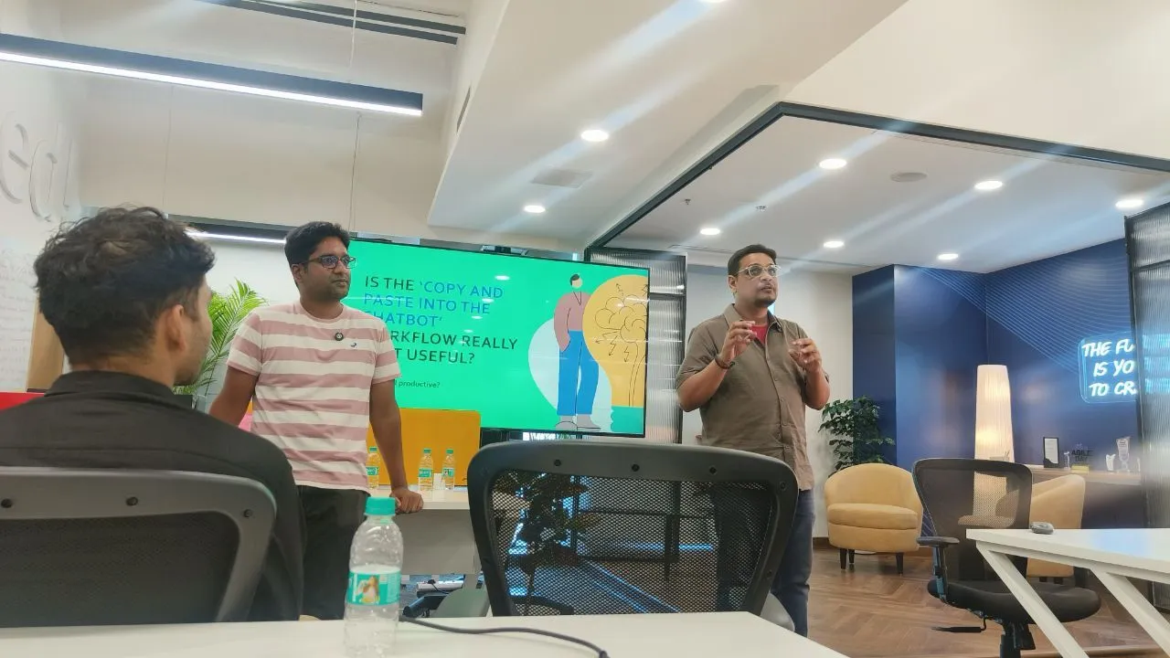 Kamal and Vivek presenting to an audience with a slide asking whether copy-pasting into a chatbot is useful