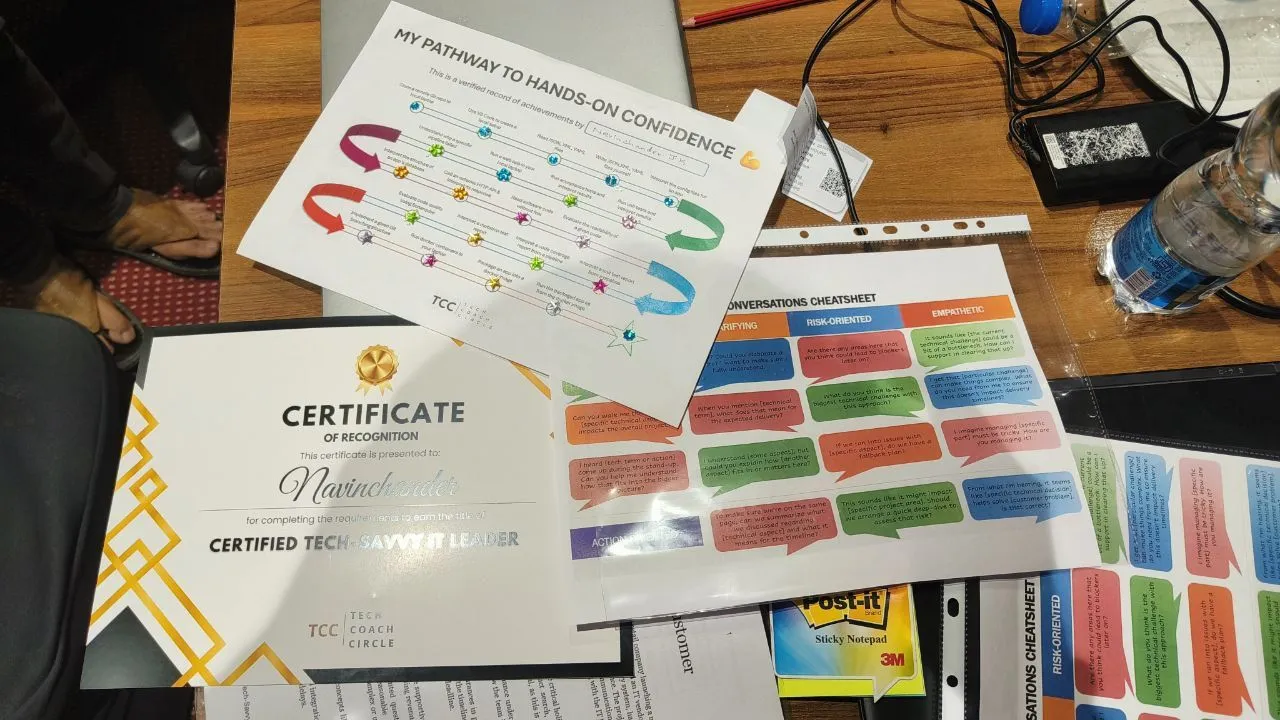 Workshop materials on a table: a certificate, a hands-on confidence pathway and a conversation cheatsheet
