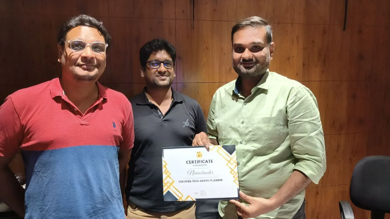 Two mentors with a graduate holding a Certified Tech-Savvy IT Leader certificate